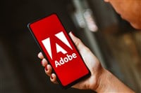 Adobe Inc. logo is displayed on a smartphone screen